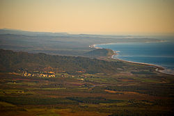 An aerial photograph of Ross, with the Tasman Sea seen to the right.