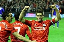 Gerrard celebrating with José Enrique and Luis Suárez in 2012