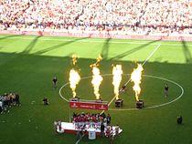 A coloured photograph of the Arsenal players celebrating their first Emirates Cup win.