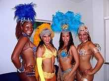 4 female samba dancers are shown posing for a picture during the 2008 Rio Carnival.