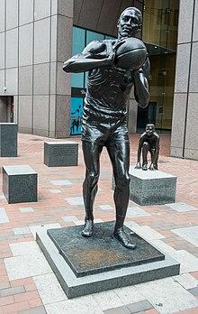A bronze statue of Russell passing a basketball