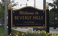 Black sign with gold lettering that says "Welcome to Beverly Hills / City of Chicago / 95th Street Beverly Hills Business Association."