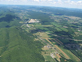 Aerial photo of Nittany Valley looking east. from Milesburg. Bald Eagle Mountain is on the left and Mount Nittany is at the upper right.