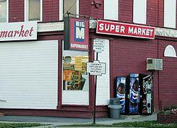 Old N.Y. State Highway signs at the corner of Utica and Cortland Streets (NYS Rt. 13) in the Village of DeRuyter. The building was the DeRuyter Big M. July 2001 photo.