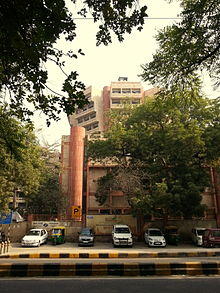 Building with trees and parked cars