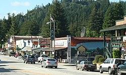 Boulder Creek at Highway 9. The mural on the hardware store, painted by John Ton in 2001, depicts the San Lorenzo Valley logging flume and train station in the 1880s.