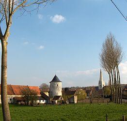 The old fortified farmhouse in white limestone and the church