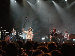 Counting Crows in Brussels, 2008. L to R: Bogios, Duritz, Immerglück, and Gillingham. Vickrey is cut off at the left, Powers is behind Duritz, and Bryson is out of frame.