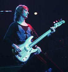 Denny Laine playing bass guitar on stage with Wings in 1976