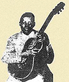 One of the only known photos of Weldon, holding his guitar in his signature Hawaiian style
