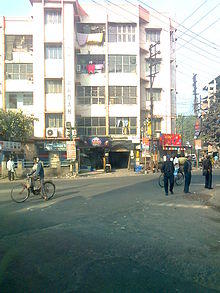 White, four-story building on a street
