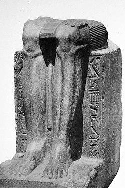 Remains of a statue of the Twelfth Dynasty reappropriated by Hyksos ruler Khyan, with his name inscribed on the sides over an erasure.[1]