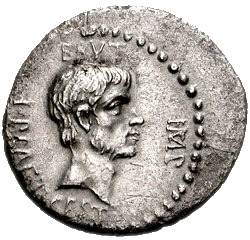 Grey coin with male face staring right