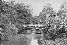 a bridge over a calm stream