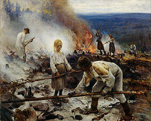 A soot-encrusted young girl working with adults
