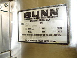 Close-up of the Bunn label on a coffee grinder.