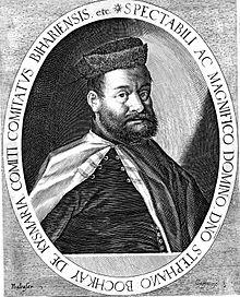 A bearded middle-aged man wearing a hat