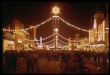 The "Gayway" at the Golden Gate International Exhibition, photographed here at night in 1940 by Charles Cushman, hosted numerous sideshow-style attractions, including "Sally Rand's Nude Ranch" (neon sign, at left), a burlesque show.