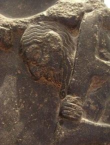 Prisoner exiting a cage, on an Akkadian Empire victory stele circa 2300 BCE, Louvre Museum.jpg