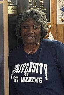 Renee Powell with image of her father, Bill (cropped).jpg