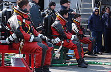 US Navy 060329-F-3759D-001 U.S. Navy divers assigned to the rescue and salvage ship USS Safeguard (ARS 50) prepare to dive.jpg