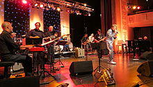 TCB Band 2013 at 12th European Elvis Festival in Bad Nauheim: Glen Hardin (p), Ron Tutt (d), James Burton (g), and Austrian singer Dennis Jale