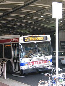 A New Flyer D60LF Route 23 bus passing under the Pennsylvania Convention Center arcade in 2006