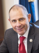 Upper-body portrait of a twentyfirst-century man in a suit.