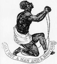 Man in chains on one knee, pleading.