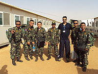 Six uniformed soldiers with a man in civilian clothing