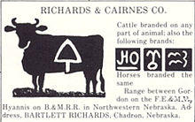 Silhouette of cow with brand marked on it: triangle pointing upward with rounded sides and a vertical projection from lower edge, like a spade