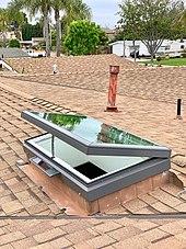A venting skylight powered by an onboard solar panel operated by a remote control to vent warm air from inside.