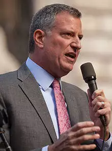 Mayor Bill de Blasio is seen talking into a microphone.
