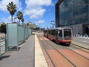 Northbound train passing Mission Rock station, April 2018.JPG