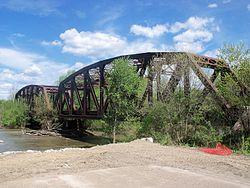 Columbus and Ohio River Railroad bridge over Tuscarawas River next to U.S. Route 36 leads into Gnadenhutten, Ohio