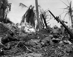 Soldiers of the U.S. 7th Infantry Division attack a Japanese blockhouse on Kwajalein
