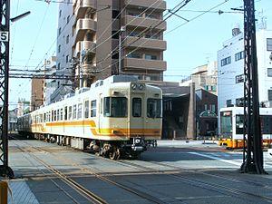 Iyotetsu tram and train meet.jpg