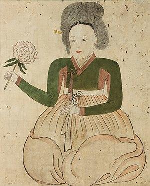 Lady on white background holding flower.