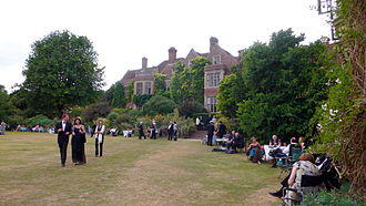 extensive gardens with English country house in the background