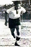 Camille Cordahi wearing a white Lebanese shirt with black shorts