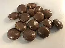A cluster of Milk Dud chocolate covered caramel balls.