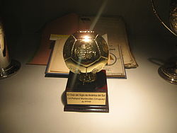 Football-shaped trophy, mounted on a base
