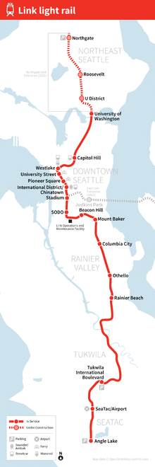 A map depicting the route of the Line 1 through Seattle, with stations marked and labeled. An additional dashed line extends further north on the future Northgate extension, with its stations also marked.
