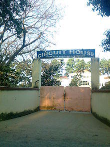 Closed gate with an arch reading "Circuit House"