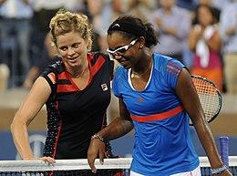 Clijsters and Duval smiling after shaking hands at the net