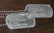 two metal US Army dog tags with Atheist/FSM stamped on them.