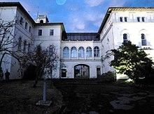 Gate and white hospital building
