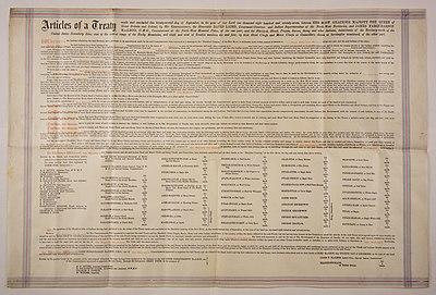A large piece of parchment paper on which is written the terms of Treaty 7.