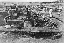 A black and white photograph of an archaeological excavation site