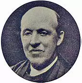 head of a middle-aged, balding man in clerical clothes